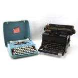 A mid-century Rheinmetall typewriter and a vintage cased Smith-Corona typewriter.