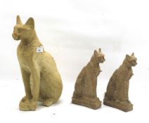 Three carved stoneware Egyptian cats.