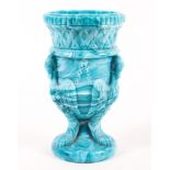 A Victorian press-moulded blue marbled slag glass vase.