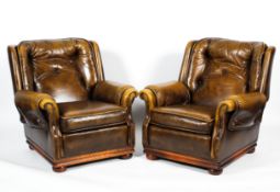 A pair of contemporary leatherette button back armchairs.