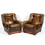 A pair of contemporary leatherette button back armchairs.