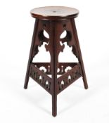 A mahogany Liberty style Arts and Crafts stool.