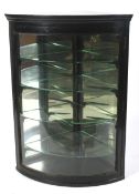 An ebonised glazed corner display cabinet, late 19th/early 20th century.