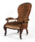 A Victorian mahogany framed spoon button back open armchair.