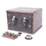 A WWII era oak cased morse code transmitter and receiver with related accessories.