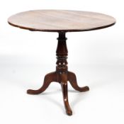 A Georgian oak and mahogany tilt top tripod table.