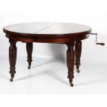 A Regency oval mahogany extending dining table.