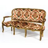 A large, late 19th century French Louis XVI-style upholstered giltwood sofa.