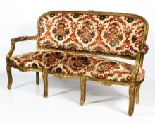 A large, late 19th century French Louis XVI-style upholstered giltwood sofa.