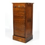 A 1930s oak tambour fronted filing cabinet.