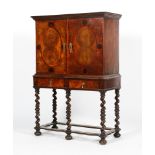 An early 20th century Continental Walnut oyster veneered 18th century style cabinet on stand.