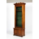 An Edwardian glazed mahogany gun cabinet.