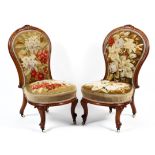 A pair of Victorian mahogany framed spoon backed lounge chairs.