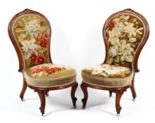 A pair of Victorian mahogany framed spoon backed lounge chairs.