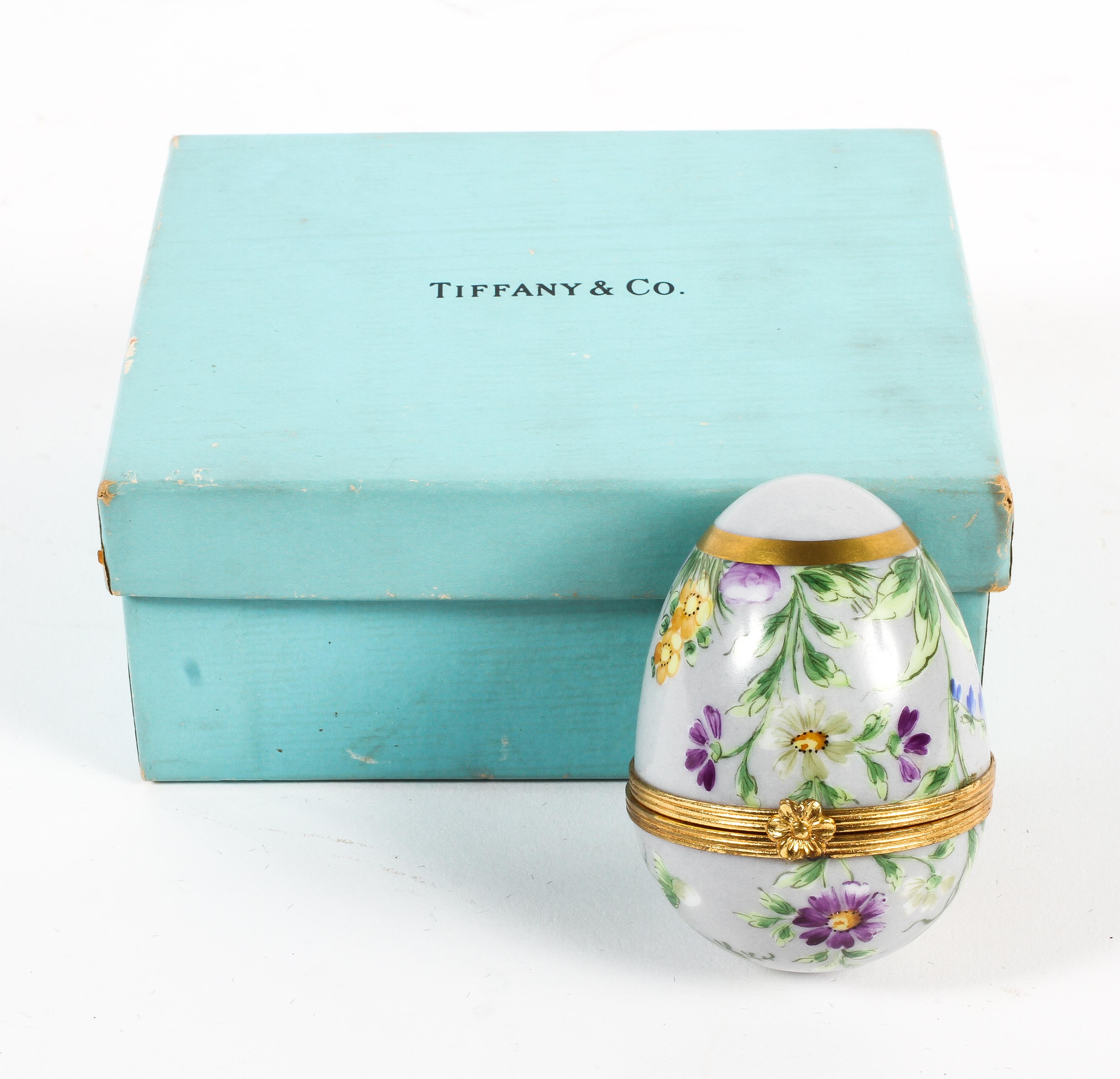 A Tiffany & Co gilt-metal mounted porcelain egg.