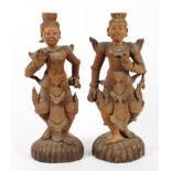 A pair of 20th century Burmese carved wood buddhistic-style figures.