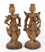 A pair of 20th century Burmese carved wood buddhistic-style figures.