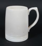 A Wedgwood Keith Murray cream glazed mug.