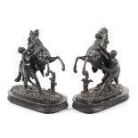 A pair of French 19th century black cast metal Marly horse groups after Guillaume Coustou.