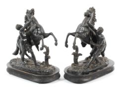 A pair of French 19th century black cast metal Marly horse groups after Guillaume Coustou.