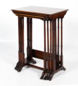 A nest of four Edwardian mahogany and cross banded "Quartteto" tables.