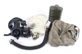 A Russian gas mask in original carry case and British gas mask.