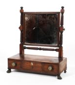 A Regency mahogany swing mirror.