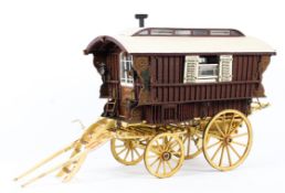 A vintage scratch built large model of a travelling caravan.