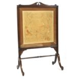 An early 19th century mahogany framed silk fire screen.