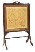 An early 19th century mahogany framed silk fire screen.