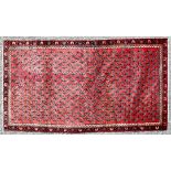 An Arak red ground rug.