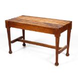 An oak Arts and Crafts style stool or luggage rack with slatted top.