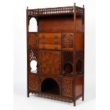 An Edwardian mahogany four sectioned cabinet of Moorish influence.