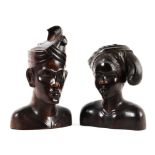 An early 20th century pair of carved hardwood busts of a Balinese man and woman.