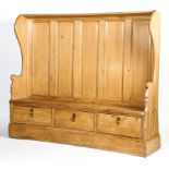 A 19th century and later curved pine wing back settle of large proportion.