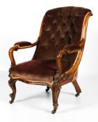 A Victorian mahogany framed upholstered button back parlour elbow chair.