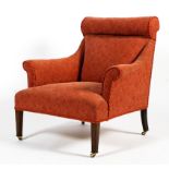 An Edwardian upholstered Howard style elbow chair.