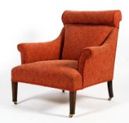 An Edwardian upholstered Howard style elbow chair.