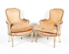 Pair of 20th century French fauteuil cream painted elbow chairs.