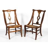 A pair of Arts and Crafts rush seated chairs.