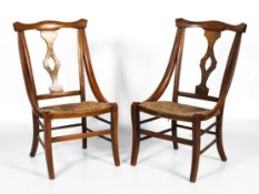 A pair of Arts and Crafts rush seated chairs.