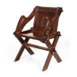 An early 20th century oak Glastonbury elbow chair.