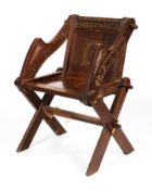 An early 20th century oak Glastonbury elbow chair.