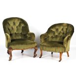 A pair of near matched late Victorian his and hers button back elbow tub chairs.