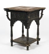 A 19th century Anglo-Indian profusely carved table of square form.