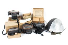 A collection of five mid-century gas masks and military helmet.