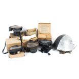 A collection of five mid-century gas masks and military helmet.