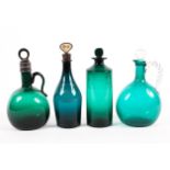 A collection of 19th century green glass decanters and bottles.