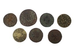 Six 17th century farthings and one half penny,