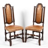 A pair of early 20th century high back leather, oak framed hall chairs.